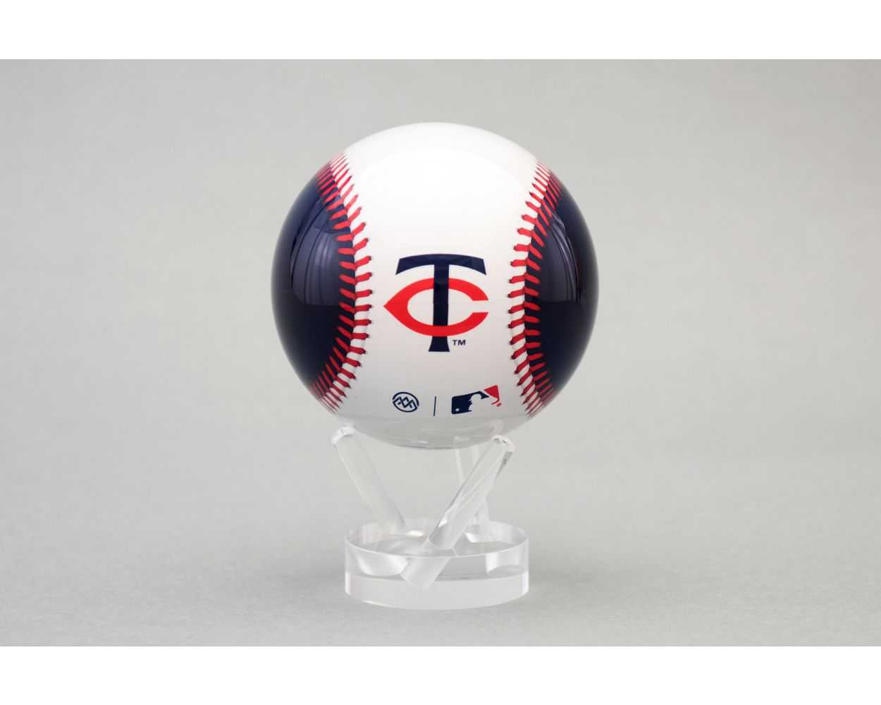 Baseball with Minnesota Twins logo on a clear stand against a gray background