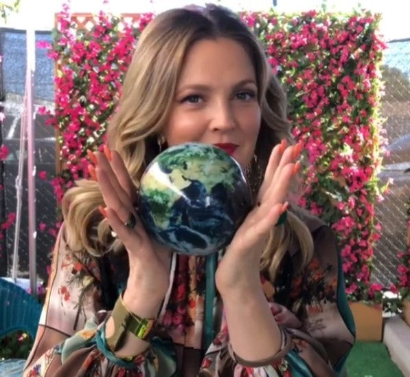 Woman holding a earth globe with a floral background