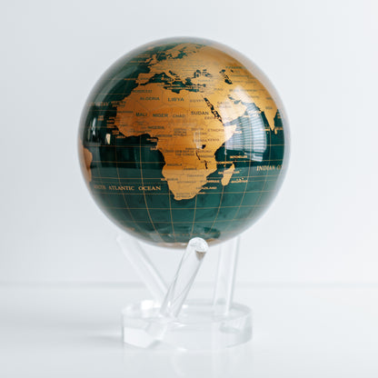 Green and Gold MOVA rotating globe with base on dining table, stylish home decoration